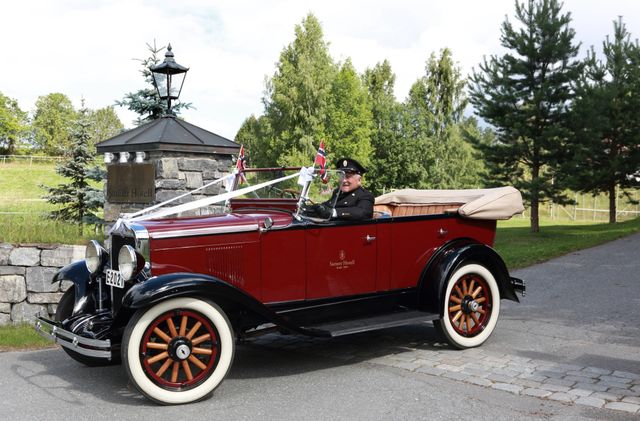 Old car decorated with flags and banners
